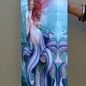 May include: A watercolor painting of a mermaid with purple tentacles and a red heart. The mermaid is depicted with long red hair and a flowing red cloth.