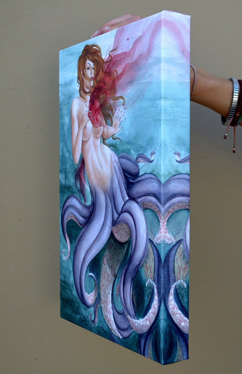 May include: A watercolor painting of a mermaid with purple tentacles and a red heart. The mermaid is depicted with long red hair and a flowing red cloth.