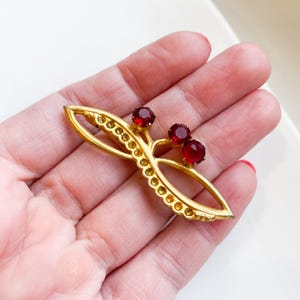 Vintage gold plated metal brooch with glass rhinestones, stone, retro costume jewelry 1970-1980, berry, floral decor
