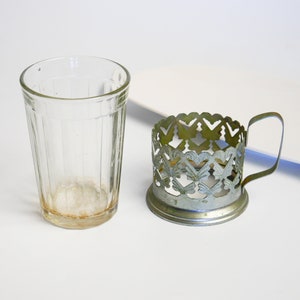 Vintage silver tone metal glass holder, with original glass. Filigree decor 1870-1970