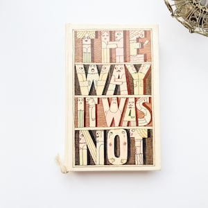 May include: A vintage paperback book with a colorful cover featuring the title "The Way It Was Not" in a whimsical font. The letters are formed by cartoon figures with various expressions and poses.