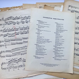 May include: A stack of vintage sheet music with a list of "Zongoraművek - Werke für Klavier" (Hungarian for "Piano Works") on the top sheet. The list includes composers such as Dohnányi, Bach, Beethoven, and Brahms.