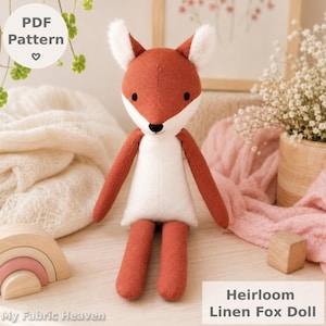May include: A stuffed fox doll made of rust-orange and white fabric with black embroidered eyes and nose. The doll has pointed ears with white inner details. A circular white label reads PDF Pattern, and a rectangular label reads Heirloom Linen Fox Doll.