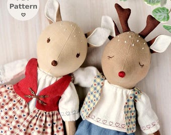 May include: Two handmade deer dolls with fabric bodies and stitched facial features. One doll wears a red vest and plaid skirt, the other a plaid vest and blue pants. The dolls are part of a PDF pattern.