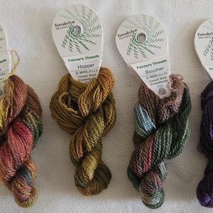 May include: Four skeins of Painter's Threads crewel wool yarn in various colors. The skeins are labeled Macke, Hopper, Boucher, and Kirchner. The yarn colors include shades of red, green, yellow, and purple.