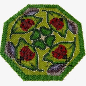 May include: A green, octagonal beaded coaster with a design of four red and black ladybugs surrounded by green leaves. The coaster is made of small, round beads.