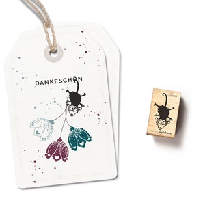 May include: White gift tags with a monkey and flower design, the word "Dankeschön" is printed on the tag. A wooden stamp with a monkey illustration and the name "Emmi" is also shown.