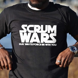 May include: Black t-shirt with white text that reads "SCRUM WARS MAY BRUTE FORCE BE WITH YOU".