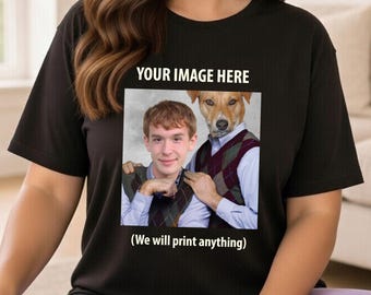 May include: Black t-shirt featuring a printed image of a person and a dog wearing matching sweaters. The text "YOUR IMAGE HERE" is above the image, with "(We will print anything)" below. A customisable design.
