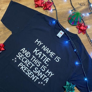 Divertente maglietta o felpa con cappuccio di Babbo Natale segreto, scritta personalizzata con nome festivo con scatola regalo di cioccolatini di Natale opzionale - 986