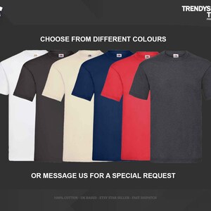May include: A collection of six short-sleeved crew neck t-shirts displayed in a row, featuring a variety of solid colors including white, black, cream, navy blue, red, and charcoal gray, with the text CHOOSE FROM DIFFERENT COLOURS above them.