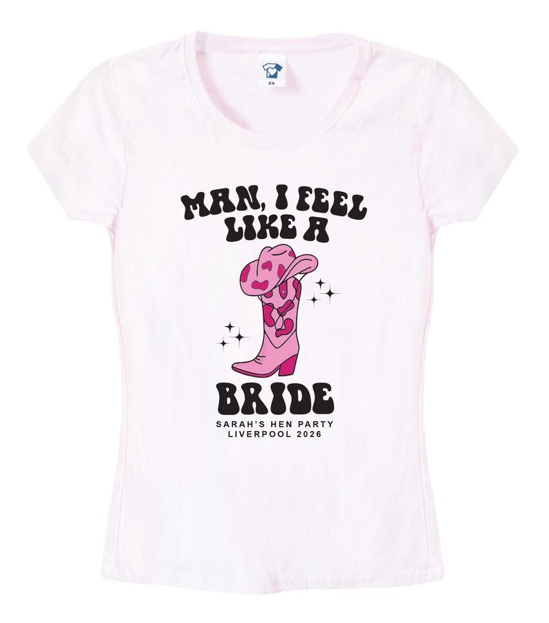 May include: Pink t-shirt with the text "Man, I feel like a Bride" in a retro font. The shirt also features a pink cowboy boot with a pink and white cow print design and the text "Sarah's Hen Party Liverpool 2026".