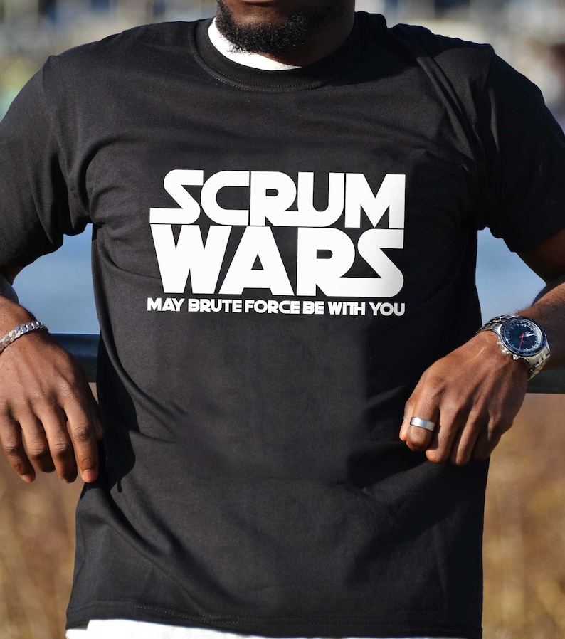 May include: Black t-shirt with white text that reads "SCRUM WARS MAY BRUTE FORCE BE WITH YOU".