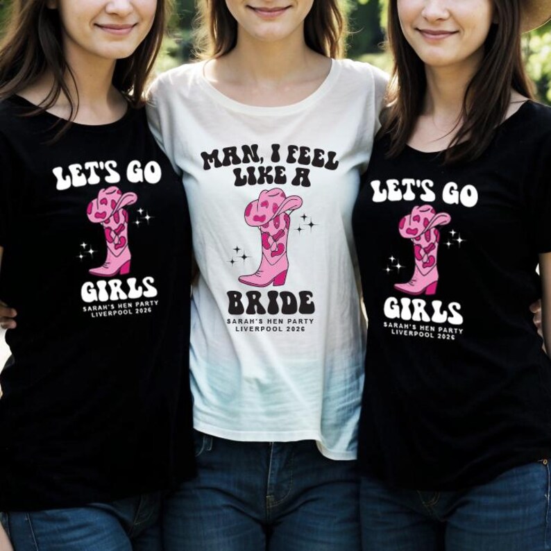 May include: Three black and white t-shirts with a pink cowboy boot graphic and text that reads "Let's Go Girls", "Man, I Feel Like a Bride", and "Let's Go Girls".