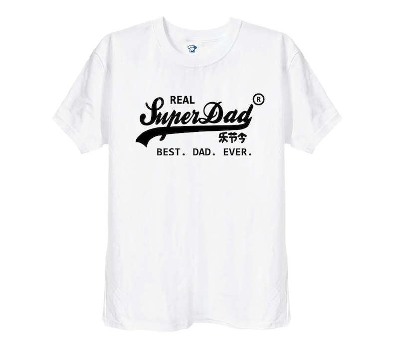 May include: A white short-sleeved t-shirt featuring black text on the chest that reads REAL SuperDad with a registered trademark symbol, followed by Chinese characters and the phrase BEST. DAD. EVER. in a clean, sans-serif font.