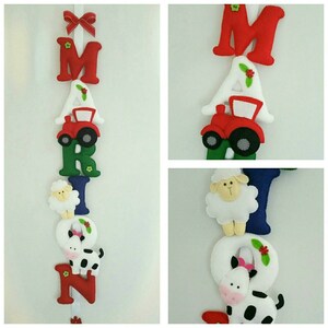May include: A felt letter banner with the name "MARIN" spelled out in colorful letters. Each letter is decorated with a farm animal, including a sheep, a cow, and a tractor.