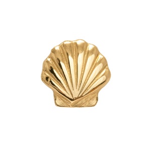 May include: A gold seashell charm with a detailed, textured design.