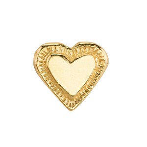 May include: A gold heart-shaped charm with a textured border.