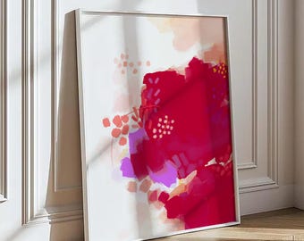 Op de afbeelding: Een vierkant ingelijst kunstwerk aan de muur met een abstracte compositie met gedurfde magenta en dieprode penseelstreken, geaccentueerd door zachte perzik, lichtroze en violette vlekken, op een witte achtergrond in een dunne witte lijst.