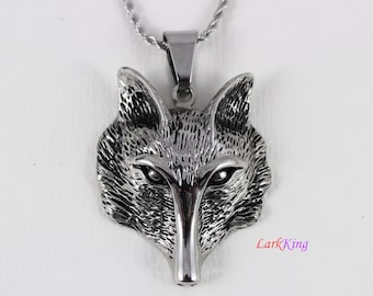May include: A silver wolf head pendant necklace. The pendant is detailed with a textured fur design and black eyes. The necklace has a silver chain.