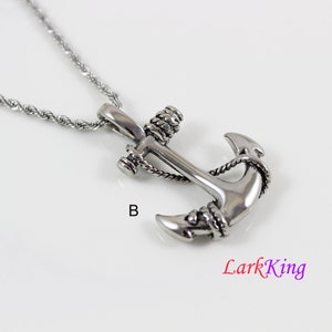 May include: Silver anchor pendant necklace with a rope design. The anchor is detailed with a rope design and has a silver chain.