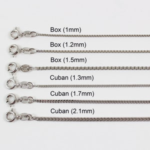 May include: Six silver chains of different widths and styles, labelled with their names and measurements in millimetres. The chains are arranged in rows from top to bottom, with the smallest chain at the top and the largest chain at the bottom. The chains are all made of silver and have a polished finish.