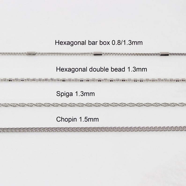 May include: Four different types of silver chains are displayed on a white background. The chains are labelled with their names and sizes: Hexagonal bar box 0.8/1.3mm, Hexagonal double bead 1.3mm, Spiga 1.3mm, and Chopin 1.5mm.