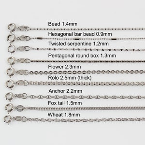 May include: A close-up of ten different types of silver chains, each with a different style and size. The chains are labelled with their names and measurements in millimetres. The chains are arranged in a row from top to bottom.