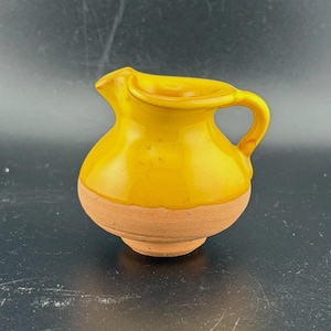 May include: A set of three ceramic mugs with a speckled, matte finish. The mugs are in shades of cream, light gray, and dark gray. Each mug has a simple, minimalist design, perfect for coffee or tea.