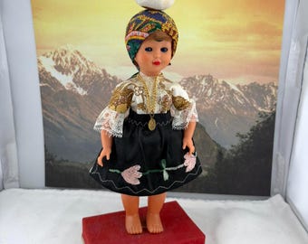 Nazarene Portugal Doll in Native Traditional Folk Costume Dress and Head-Wrap with a Bundle of Laundry on top, Attached to Stand