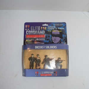 May include: A box of four diecast toy soldiers in military uniforms. The box is blue and features a picture of General George S. Patton and the text "Elite Command Collector's Series".