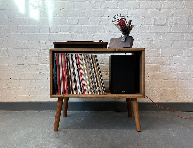 70 cm wide mid century style wooden record player stand in a medium finish.