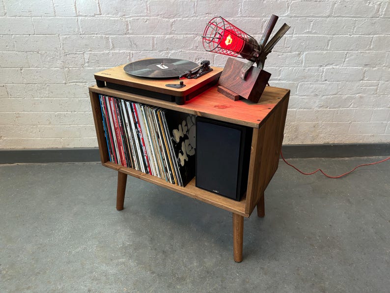 70 cm wide mid century style wooden record player stand in a medium finish.
