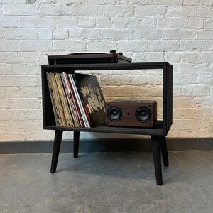70 cm wide mid century style wooden record player stand in an ebony finish.