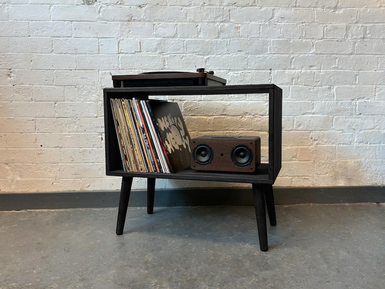 70 cm wide mid century style wooden record player stand in an ebony finish.