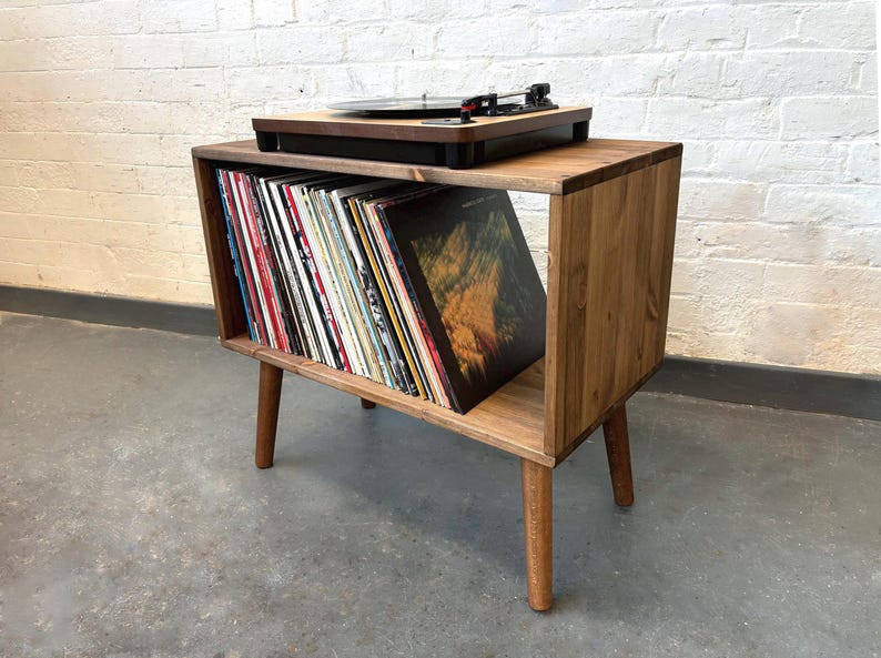 70 cm wide mid century style wooden record player stand in a medium finish.