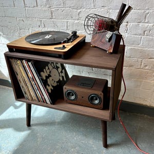 70 cm wide mid century style wooden record player stand in a dark finish.