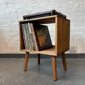 50 cm wide mid century style wooden record player stand in a medium finish.