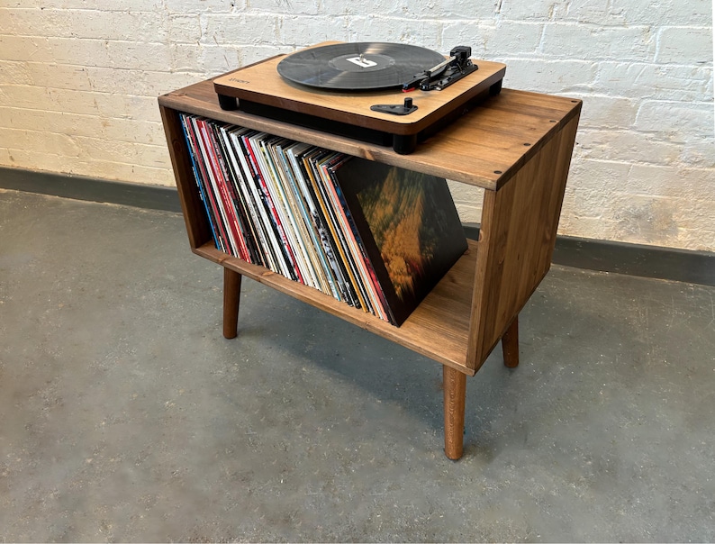 70 cm wide mid century style wooden record player stand in a medium finish.