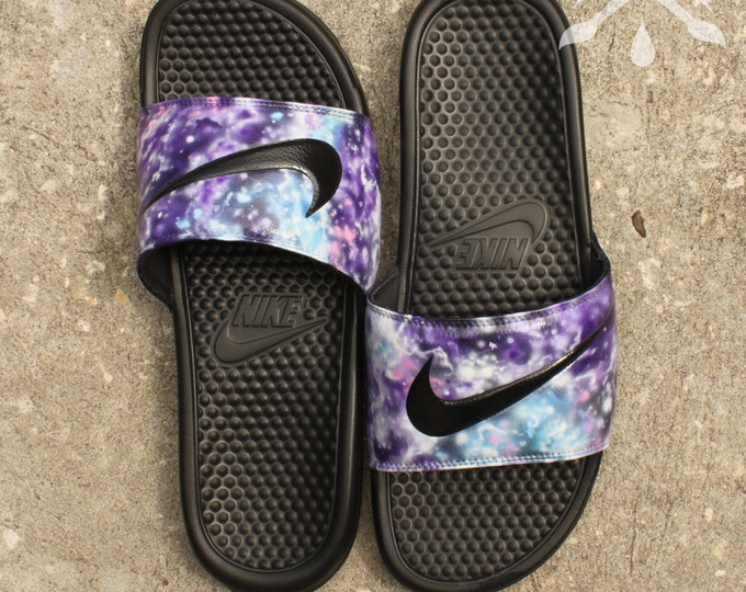 purple nike slides with gold nike sign