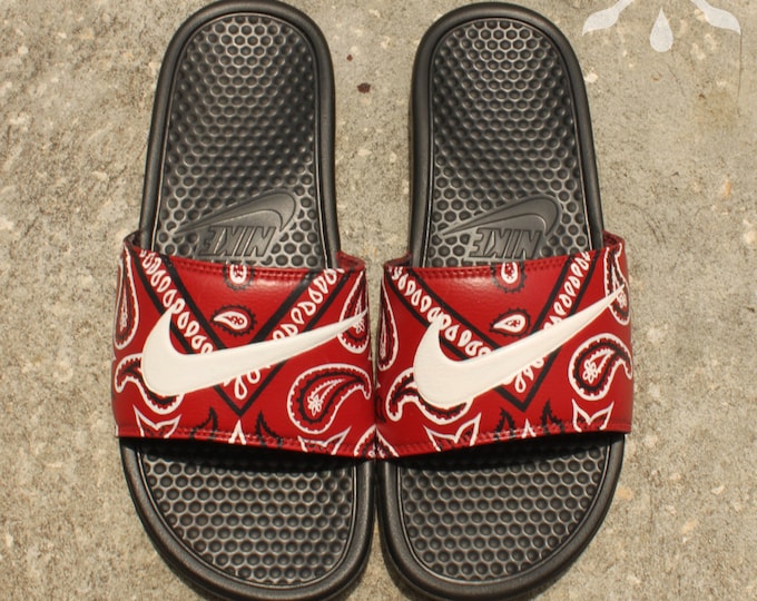 red nike sandals with gold check