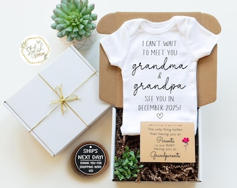 May include: A white gift box with a white ribbon and a white bodysuit with the text "I can't wait to meet you grandma & grandpa See you in December 2025!"  The box also contains a small card with the text "The only thing better than having you as Parents is our baby having you as Grandparents".