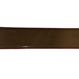 May include: A rectangular brown ceramic tile with a slightly raised edge and a smooth, glossy finish.