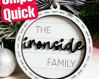 May include: White wooden ornament with black lettering that reads "The Ironside Family" and lists the names of family members around the edge.