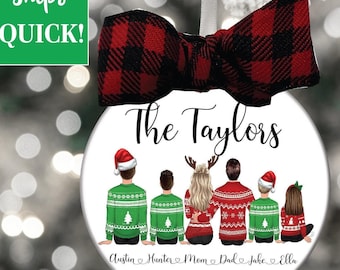 May include: A white round Christmas ornament with a red and black plaid bow. The ornament features a family of six wearing Christmas sweaters with the text "The Taylors" at the top and "Austin, Hunter, Mom, Dad, Jake, Ella 2022" at the bottom.