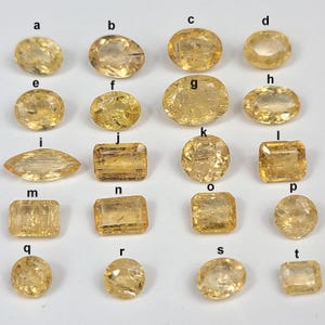 Selection of faceted imperial topaz labeled a–t, mixed shapes (oval, round, emerald-cut, cushion, marquise/navette), champagne-gold to honey tones with lively inclusions; sizes approx. 5–10 mm and 0.3–1.5 ct each; clean girdles and bright tables ideal for bezel, prong, or wire-wrap settings, earring pairs, rings, and petite pendants.