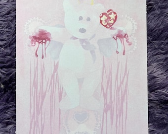 May include: A pink print featuring a white teddy bear with a halo and a heart-shaped tag. The bear is depicted with blood dripping from its arms, set against a backdrop of lace and vertical lines. The artist's name, @rjcrowart, is visible.