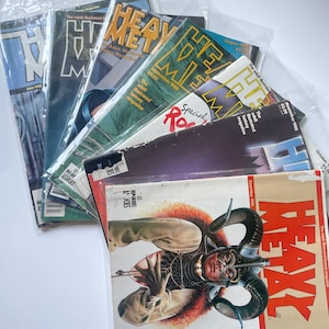 May include: A stack of vintage Heavy Metal magazines from 1980. The covers feature colorful illustrations and the text "The adult illustrated fantasy magazine".