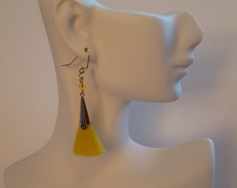 May include: Yellow tassel earrings with a gold-toned metal top and a crystal bead.