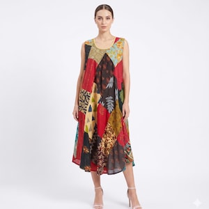 May include: A sleeveless midi-length patchwork dress. The dress features a variety of patterns and colours, including red, black, yellow, and blue. The dress has a round neckline and a flowing skirt.